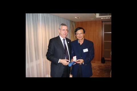 David Hughes presents a CIBSE gold medal to Patrick Yip